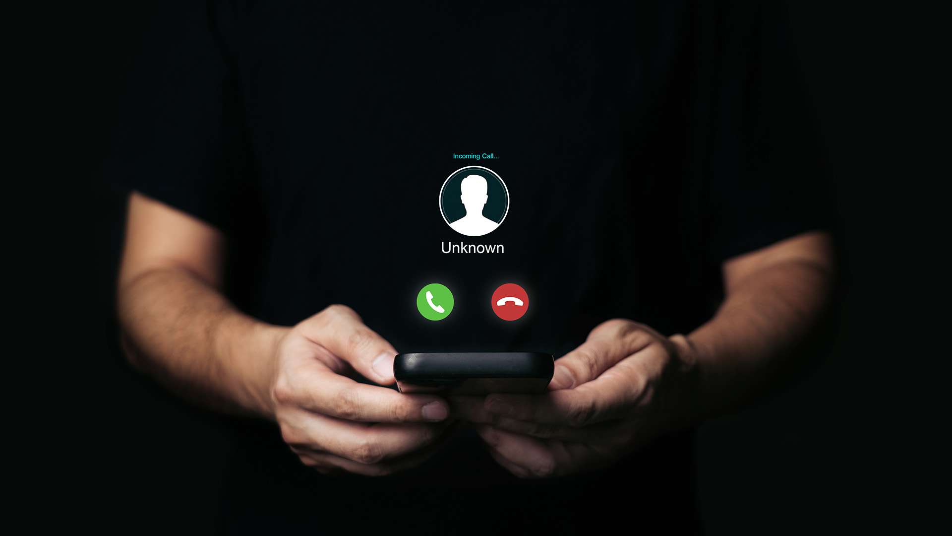 Person holding a smartphone with an “Unknown” incoming call screen—illustrating a phone scam (vishing) warning.